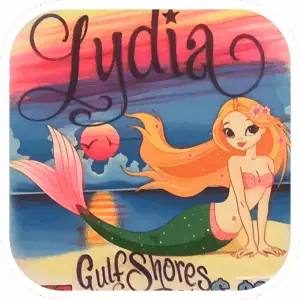 Image of Mermaid laying on the beach with a rainbow sunset in the background